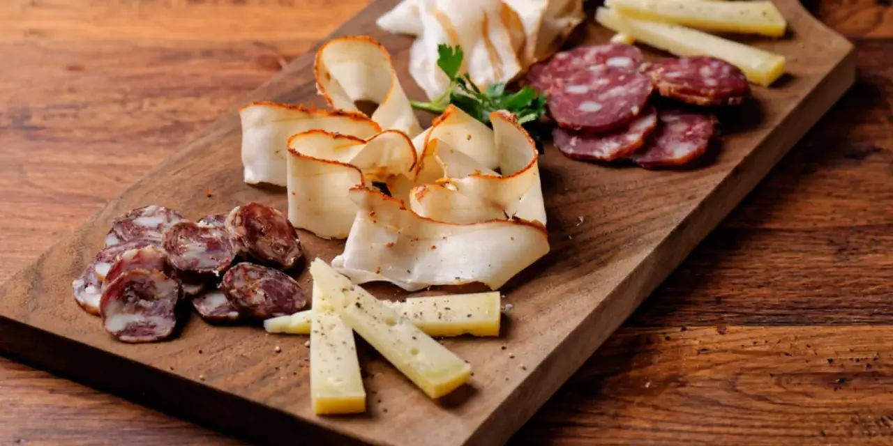 Un invitante tagliere di salumi per aperitivo con formaggio e salame, pronto per essere gustato.