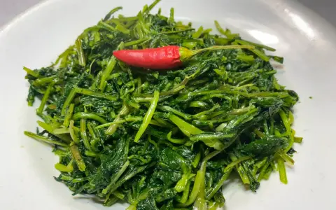Cicoria in padella, un contorno semplice e gustoso, impreziosito da un peperoncino rosso.