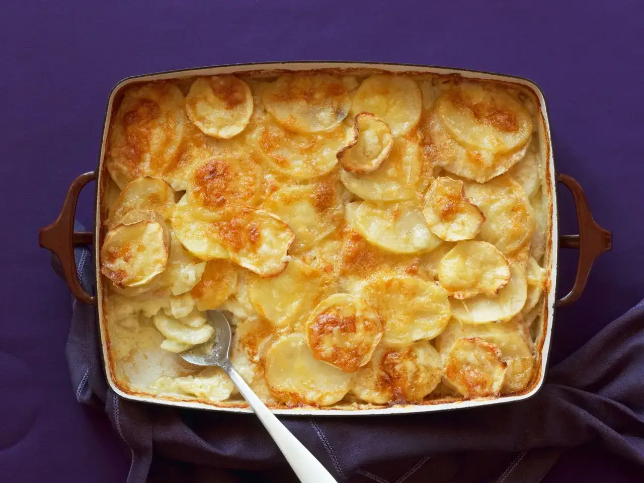 Parmigiana di patate dorata e cremosa, appena sfornata, pronta per essere gustata.